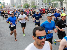 Runners begin the Scotiabank Ottawa Marathon along Elgin Street on Sunday May 25, 2014. (Errol McGihon/Ottawa Sun/QMI Agency)