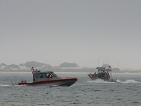 Rescue crews search waters near Navarre Bridge, east of Pensacola, Florida March 11, 2015 after an Army helicopter crashed during a night time training mission.  REUTERS/Michael Spooneybarger