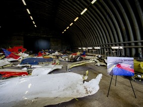 A picture taken on March 2, 2015 shows the wreckage of the Malaysia Airlines flight MH17 which was shot down over Ukraine in July 2014, laid out in a hangar on  Gilze-Rijen airbase in the southern Netherlands. The first of around 500 relatives of those killed in the shooting down of MH17 visited the wreckage at a Dutch airbase on March 2, investigators said. The wreckage was brought to the Gilze-Rijen base in the southern Netherlands late last year as part of a probe into what exactly shot down the Boeing 777 in July, killing all 298 people on board. Around two-thirds of those killed were Dutch, while citizens from a total of 11 countries died in the disaster.  AFP PHOTO / ANP / ROBIN VAN LONKHUIJSEN
