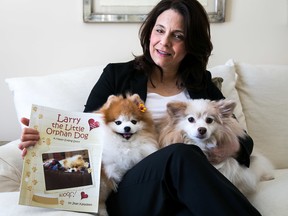 Tim Miller/The Intelligencer
Jean Kaladeen wrote the children's book Larry the Little Orphan Dog after her experiences adopting a Pomeranian rescued from a puppy mill and nursing him back to health. Kaladeen is pictured here with Lola (left), Larry's daughter who was rescued from the same mill, and Maggie, another rescue dog.