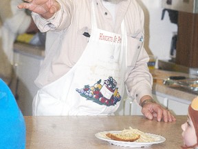 Knights of Pythias member Bob Micks serves some food at the Knights of Pythias Hall on Saturday, March 7. The Knights of Pythias held a spaghetti dinner fundraiser to help out member Jerry Blake, as he had a fire in his home last month.