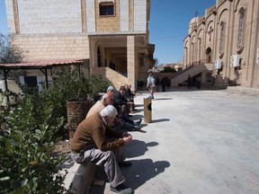 Displaced Assyrians, who fled from the villages around Tel Tamr, gather outside the Assyrian Church in al-Hasaka city, as they wait for news about the Assyrians abductees remaining in Islamic State hands, March 9, 2015. Islamic State released 19 Assyrian Christian captives in Syria on March 1 after processing them through a sharia court, a monitoring group which tracks the conflict said. More than 200 Assyrians remain in Islamic State hands, said the British-based Syrian Observatory for Human Rights. Picture taken March 9, 2015. REUTERS/Rodi Said