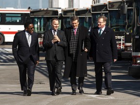 Councillor Michael Thompson, from left, TTC Chair Josh Cole, Mayor John Tory and budget dhief Gary Crawford arrive at the TTC Yard in Scarborough for a press conference on Thursday, March 12, 2015. (Craig Robertson/Toronto Sun)