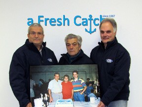 Seacore’s Gerry Battaglia, left, Tony Cristoforo and Joe Nestico hold a photo of the trio when they started out.