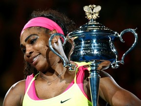 Serena Williams poses with the trophy after defeating Maria Sharapova in the women's final at the Australian Open in Melbourne January 31, 2015.  (REUTERS/Thomas Peter)