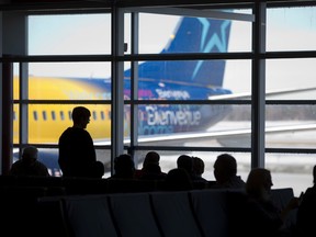 Travellers wait in the departure lounge at London International Airport to board. (Free Press file photo)