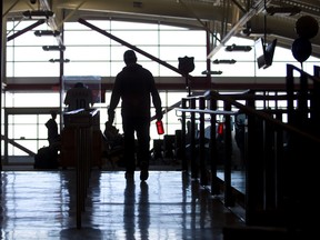 A traveller walks towards the departure lounge at London International Airport in London. (Free Press file photo)