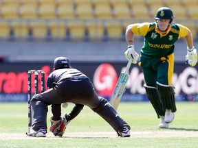 South Africa’s David Miller is not out as United Arab Emirates’ Saqlain Haider tries to run him out during their Cricket World Cup match in Wellington, New Zealand, yesterday. South Africa won by 146 runs. (Reuters)