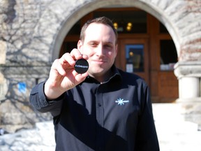 St. Thomas Economic Development Corporation general manager Sean Dyke holds a #stthomasproud pin in front of city hall on Thursday. The pins are part of a social media campaign aimed at promoting what's good about the city and what makes residents and ex-pats proud to be from here. (Ben Forrest, Times-Journal)