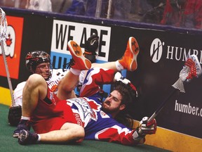 Buffalo’s Ryan Benesch (left) and Toronto’s Scott Johnston hit the floor earlier this season. (JACK BOLAND/Toronto Sun)