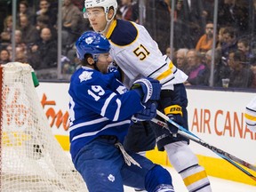 Leafs winger Joffrey Lupul, seen here getting slammed by Sabres’ Nikita Zadorov on Wednesday, was bounced to the fourth line during the game. It’s been another rough year for Lupul as he has dealt with injuries, trade rumours and unfounded innuendo. (Ernest Doroszuk/Toronto Sun)