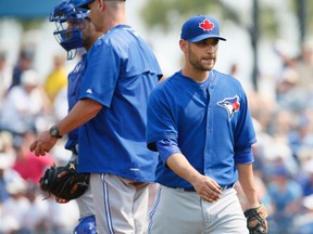 Marco Estrada heads off the mound after lasting just two-thirds of an inning in Thursday's exhibition game against the Rays, allowing seven earned runs. (STAN BEHAL, Toronto Sun)
