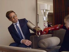 Robert Downey Jr. presents a bionic arm to young fan Alex. (Facebook video)
