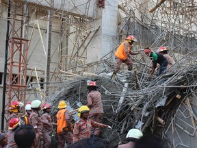 Rescue workers are seen at the scene of a collapsed cement factory in the port town of Mongla, southwest of Dhaka, March 12, 2015. (REUTERS/Alif Khatok)