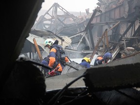This handout picture taken and released by Russia's Emergency Ministry on March 12, 2015, shows members of the emergency services working at the remains of a shopping mall in Kazan. (AFP PHOTO/RUSSIA'S EMERGENCY MINISTRY)