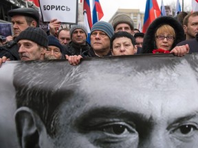 *TO GO WITH AFP STORY BY FRAN BLANDY*(FILES)A file picture taken on March 1, 2015 shows Russia's opposition supporters carrying a banner bearing a portrait of Kremlin critic Boris Nemtsov during a march in central Moscow. After years with no real political power and a steady Kremlin crackdown on dissent, Russia's opposition was in the doldrums even before the assassination of one of its most vocal activists, Boris Nemtsov. AFP PHOTO / ALEXANDER UTKIN