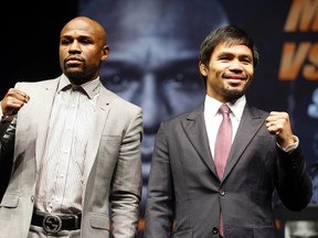 Floyd Mayweather (left) and Manny Pacquiao pose at a news conference ahead of their upcoming bout in Los Angeles March 11, 2015. (REUTERS/Lucy Nicholson)