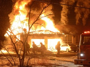 Firefighters work to contain a blaze on Old Guelph Rd. in Hamilton early Friday, March 13, 2015. (ANDREW COLLINS/Special to the Toronto Sun)