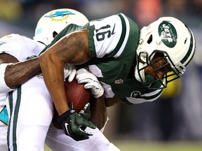 Percy Harvin of the New York Jets is tackled by a Miami Dolphins defender during NFL play at MetLife Stadium December 1, 2014 in East Rutherford, N.J. (Elsa/Getty Images/AFP)