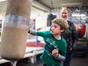 Jackson Cook, 8, and his mother Sara Cook at the Cabbagetown Boxing Club. They will participate in the Shamrock and Sneakers 4 km Run to kick off the St. Patrick's Day parade on March 15, 2015. (Ernest Doroszuk/Toronto Sun)