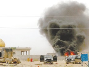 Smoke rises from an explosives-laden military vehicle driven by an Islamic State suicide bomber which exploded during an attack on the southern edge of Tikrit on Thursday. Iraqi security forces and mainly Shi?ite militia exchanged fire sporadically with Islamic State fighters in Tikrit on Thursday, a day after they pushed into Saddam Hussein?s home city in their biggest offensive yet against the militants. A Reuters photographer saw one car bomb explode on the southern edge of the city, and security officials say Islamic State fighters have booby-trapped abandoned buildings. (Thaier Al-Sudani/Reuters)