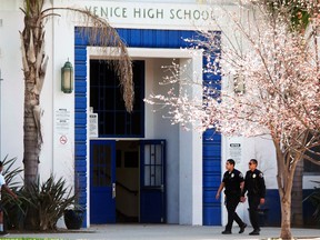 Police officers walk on campus at Venice High School where authorities are investigating allegations of sexual assaults centered on students at the high school in Los Angeles, March 13, 2015. (JONATHAN ALCORN/Reuters)