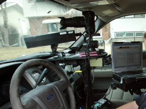 A peace officer operates a photo radar unit in 2013.
Perry Mah/QMI AGENCY