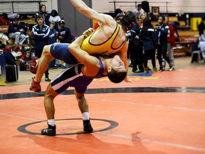 Western Mustangs wrestler Steven Takahashi throws his opponent during the 2015 OUA Championships (submitted photo).