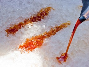 Maple syrup being poured on snow to make taffy at Proulx Sugarbush in the east end of Ottawa. ERROL MCGIHON/OTTAWA SUN