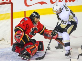 Calgary Flames goalie Jonas Hiller (1) makes a save on Pittsburgh Penguins centre Sidney Crosby during the second period at Scotiabank Saddledome. (Sergei Belski/USA TODAY Sports)