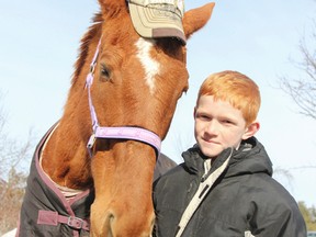 Nine-year-old Brandon Heyman and his horse Karazan joke around at Heymans home on McConnell Road in South Frontenac, Ont. on Friday March 13, 2015. Heyman saved fellow red-head Karazan from being slaughtered by using his birthday money to purchase the 17-year-old horse. Julia McKay/The Kingston Whig-Standard/QMI Agency