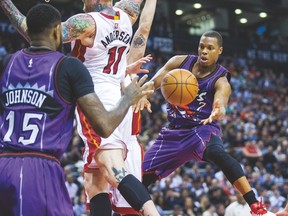Raptors guard Kyle Lowry passes the ball to Amir Johnson during Fridaky night's game against the Miami Heat. (ERNESET DOROSZUK/Toronto Sun)