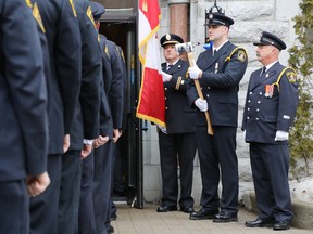 Members of Belleville Fire Department stand at attention as the casket of Capt. (ret.) Mike Barrett is being carried inside St. Michael The Archangel Roman Catholic Church Saturday, March 14, 2015. Barrett, 59, died peacefully at Kingston General Hospital on March 8, while surrounded by his family. - Jerome Lessard/Belleville Intelligencer/QMI Agency