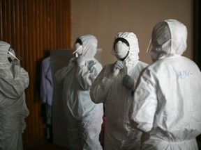 Sierra Leonean doctors practice wearing protective clothing in the Ebola Training Academy in Freetown, Sierra Leone, December 16, 2014. REUTERS/Baz Ratner