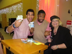 Show me the money! Grey Cup Champions Anthony Parker and Keon Raymond join Mountain Rose Women's Shelter Association Executive Director Cindy Easton in Rocky Mountain House. The two Calgary Stampeders helped raise an extra few thousand dollars at the MRWSA Gala & Auction.