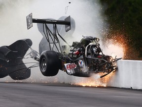 NHRA top fuel dragster driver Larry Dixon crashes after his car broke in half during qualifying for the Gatornationals at Auto Plus Raceway at Gainesville, Fla. Dixon walked away from the incident. (Mark J. Rebilas/USA TODAY Sports)