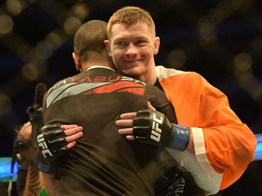 Joseph Duffy hugs his trainer after the win during UFC action in Dallas, TX. (Green/QMI Agency)