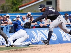 Blue Jays’ Ryan Goins slides under the tag of Yankees third baseman Alex Rodriguez in the sixth inning yesterday. (Stan Behal/Toronto Sun)