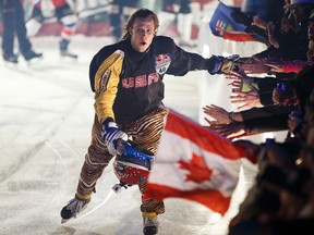 American skater Daniel Bergeson (40) high fives fans during the Red Bull Crashed Ice Ice Cross Downhill World Championship in Edmonton, Alta., on Saturday, March 14, 2015. Ian Kucerak/Edmonton Sun/ QMI Agency