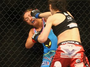Carla Esparza fights with Joanna Jedrzejczyk in the Women's Strawweight bout during the UFC 185 event at American Airlines Center.  (Ronald Martinez/AFP)