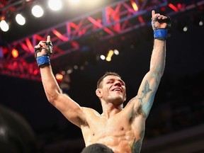 Rafael dos Anjos celebrates his win against Anthony Pettis in the Lightweight Title bout during the UFC 185 event at American Airlines Center on Saturday. Photo by Ronald Martinez/Getty Images-AFP