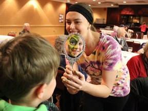 Gage Miller, 9, of Petrolia, Ont., checks out the work of face painter Angela Green at the first Sarnia Scottish Festival on Saturday March 14, 2015 in Sarnia, Ont. Highland dancers, fiddlers and pipers entertained crowds during the all-day event at the Holiday Inn. Barbara Simpson/Sarnia Observer/QMI Agency