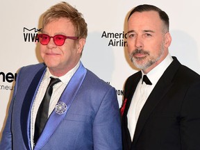 Sir Elton John and his husband David Furnish arrive at the 2015 Elton John AIDS Foundation Oscar Party in West Hollywood, California February  22, 2015. REUTERS/Gus Ruelas