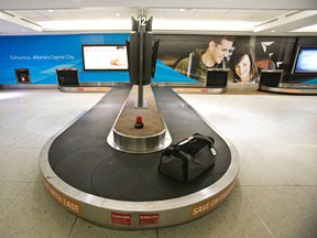A lone piece of baggage sits unclaimed on a carousel at the Edmonton International Airport in December 2013. Codie McLachlan/Edmonton Sun/QMI Agency