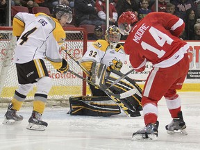 Soo Greyhounds winger Bryan Moore whiffs on a rebound off Sarnia Sting goalie Justin Fazio as Jeff King also tries to get his stick on the bouncing puck, in Ontario Hockey League action Saturday, March, 14, 2015 at Essar Centre in Sault Ste. Marie, Ont. (MICHAEL VERDONE/SAULT STAR/QMI AGENCY)