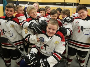 Ayden Day-Kennedy (c), defence man for the 10 A3 Heritage Victoria Hawks, is seen with his teammates in Winnipeg, Man. Sunday March 15, 2015. The team's parents gathered equipment together for Ayden after his gear was stolen from his father's car.Brian Donogh/Winnipeg Sun/QMI Agency