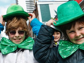 The St. Patrick's Day parade attracted a big crowd, including Ronan, 8, and Claran, 11. (DAVE THOMAS, Toronto Sun)