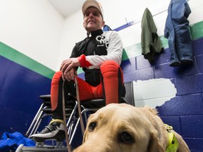 Blind and deaf speed skater Kevin Frost chills with his dog Lewis before heading to the ice surface to train at the Bob McQuarrie Recreation Complex in Orleans on Friday, March 13, 2015. 
Errol McGihon/Ottawa Sun/QMI Agency