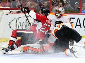 Ottawa Senators' Erik Condra crashes into Philadelphia Flyers goaltender Ray Emery during NHL hockey action at the Canadian Tire Centre on Sunday, March 15, 2015. (Errol McGihon/Ottawa Sun/QMI Agency)