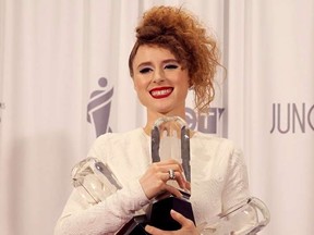 Singer Kiesza poses backstage with the three Juno awards that she won at the 2015 Juno Awards in Hamilton, Ontario, March 15, 2015.    REUTERS/Fred Thornhill